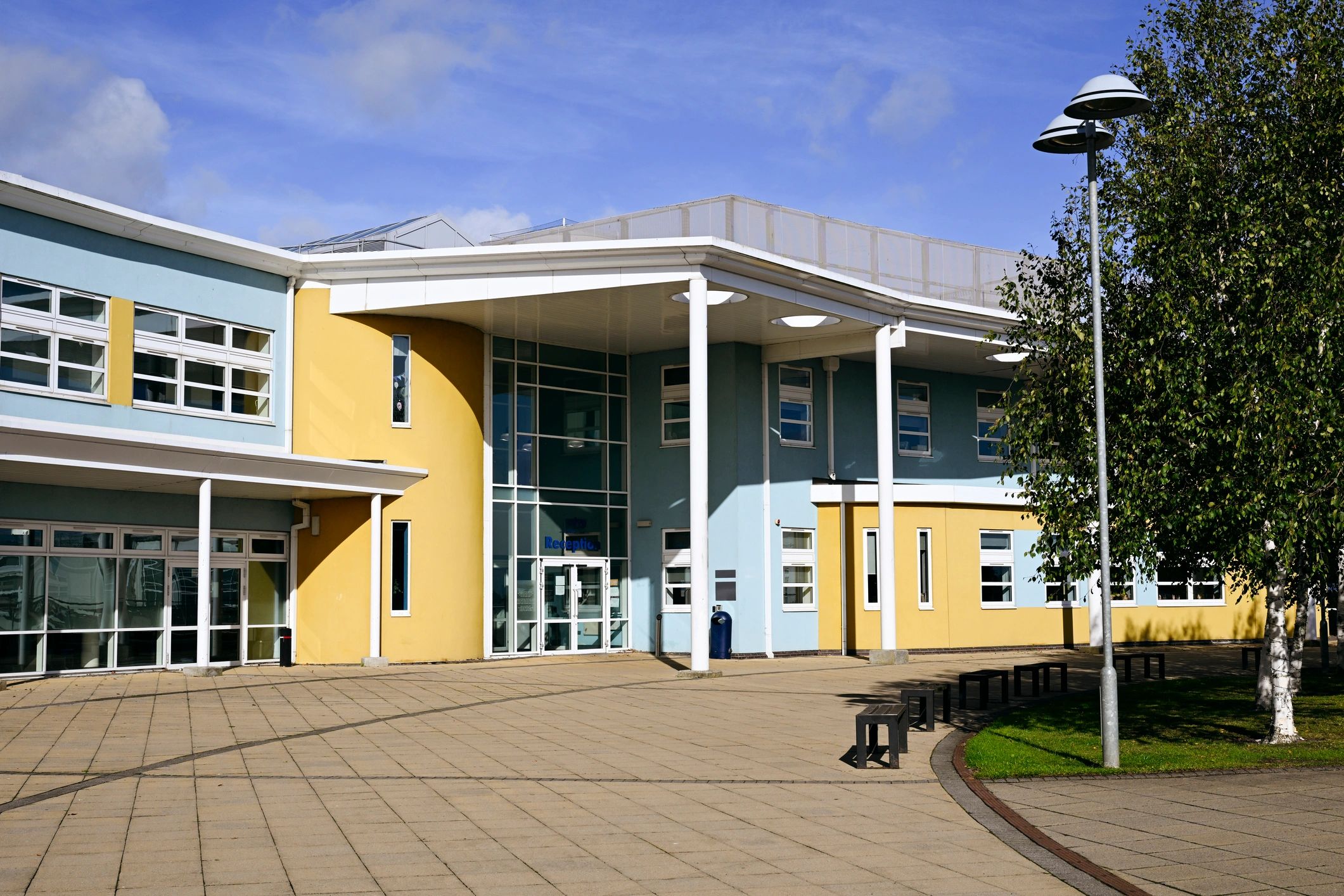 High school building exterior with blue and yellow detail